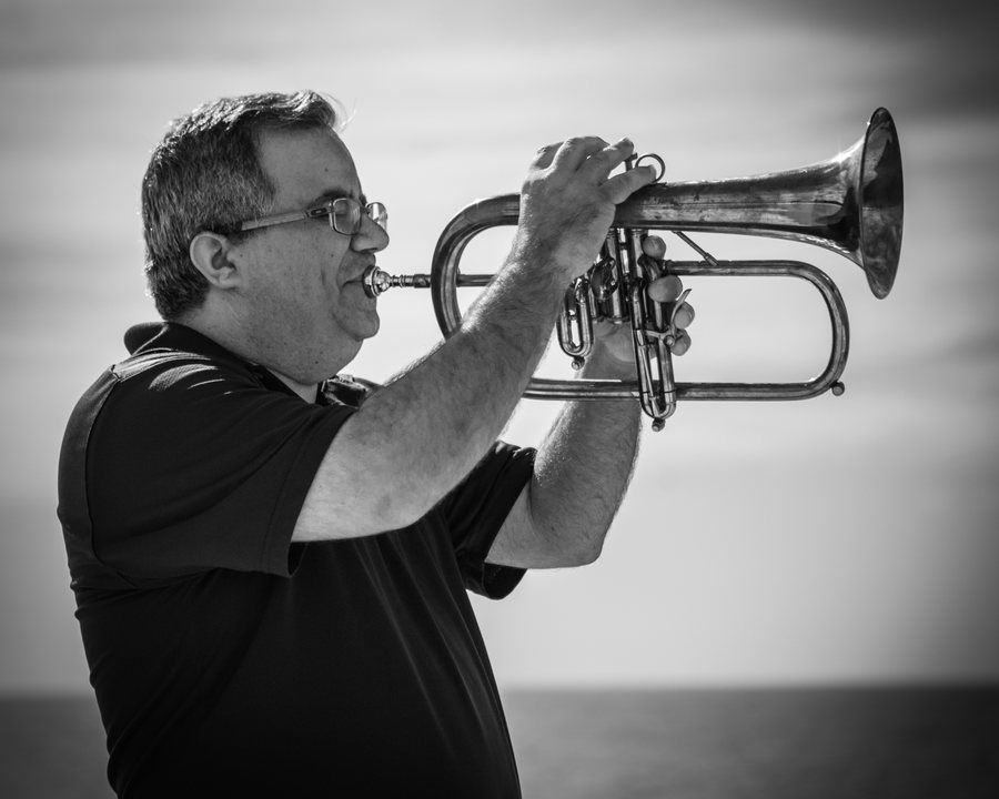 Allen J. Venezio playing trumpet, black and white