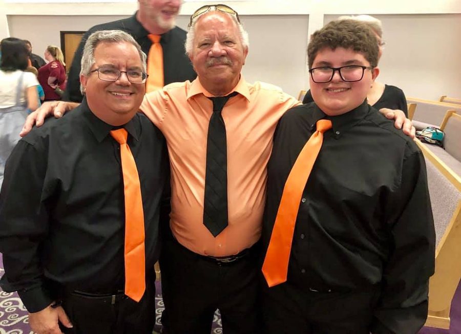 Three players in orange ties in a big band section