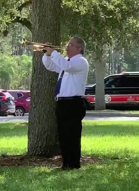 Performing Taps outdoors at a 9-11 remembrance ceremony