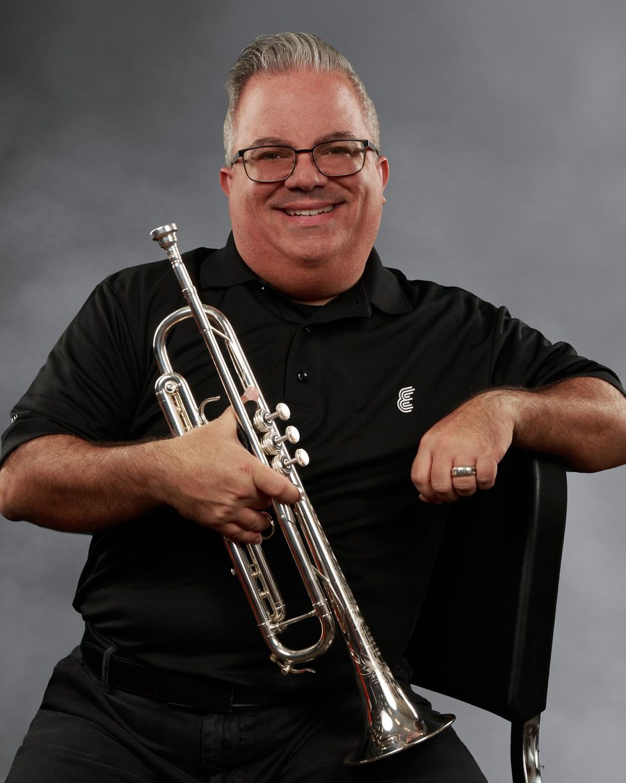 Studio portrait holding a trumpet