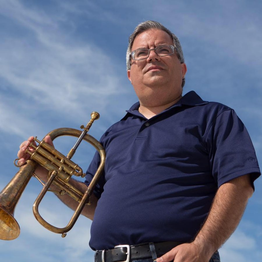 Allen J. Venezio playing flugelhorn outdoors