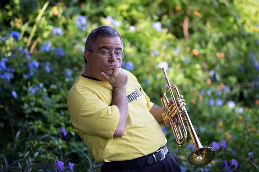 Seated outdoors with trumpet