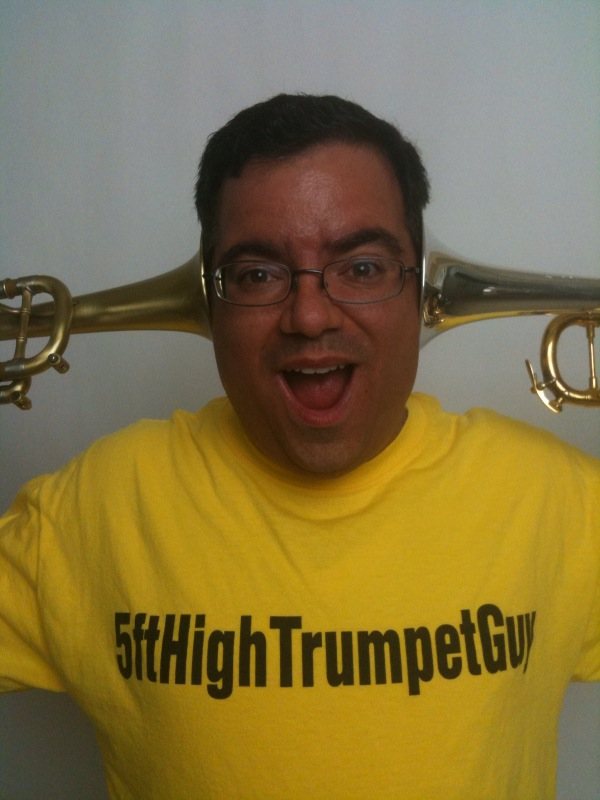 Grinning behind the trumpet bell
